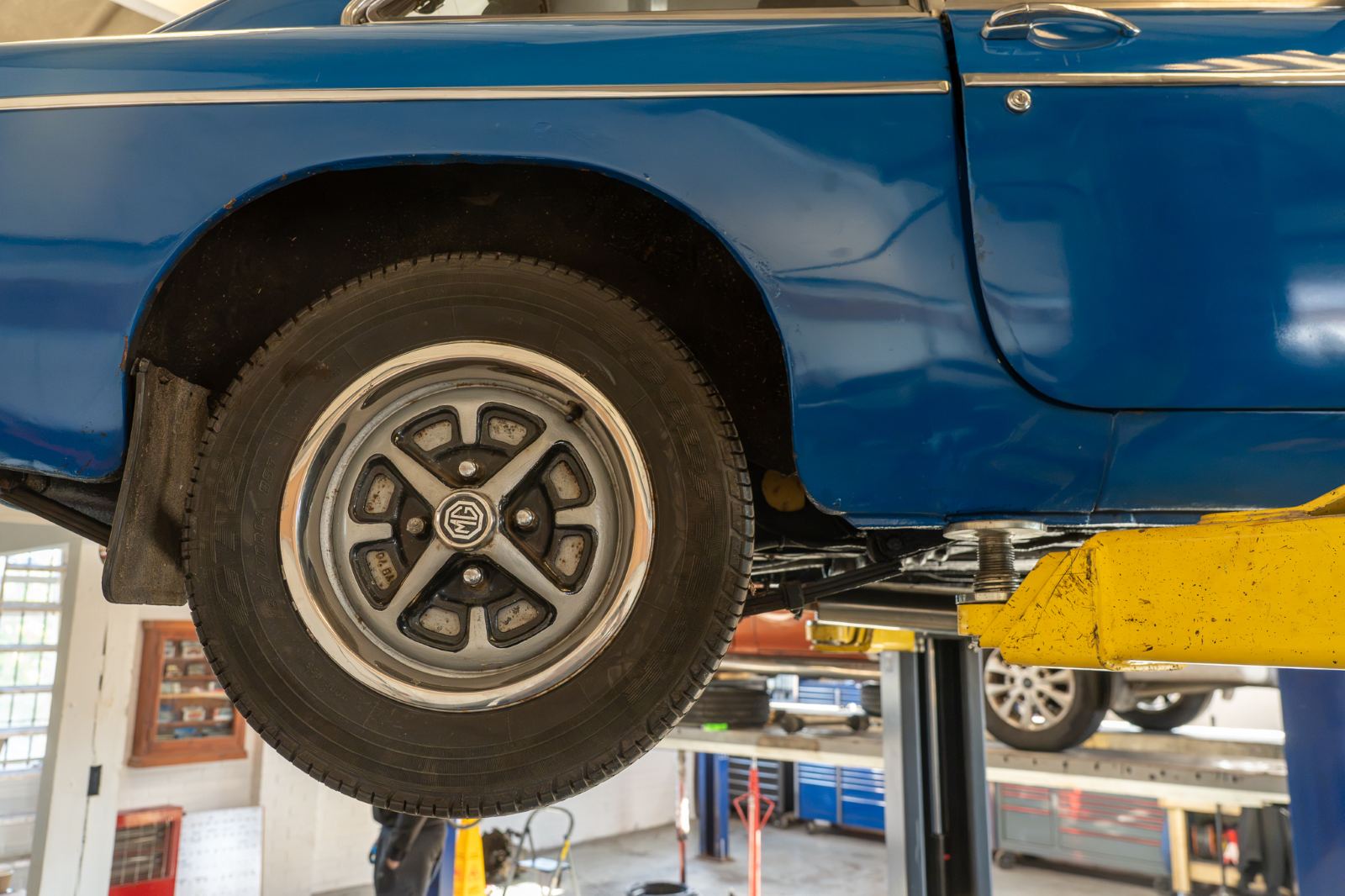 A wheel and tyre on a car raised on the lift